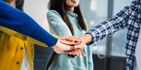 university classroom, diverse group of young students Asian collaborate study together, sharing smiles and insights around desks, exemplifying the joy of learning and friendship in higher education.