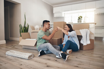 Young couple, celebrate and moving to new home with boxes for renovation, investment or relocation....