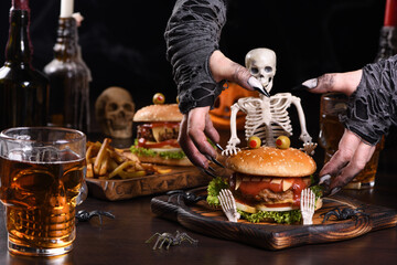 The witches hands want to grab the Monster Burger on the sitting skeleton. Perfect Halloween Party...