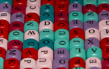 Close-up with cubes with letters in various colors with selective focus. Background image with colorful blocks with various alphabet letters