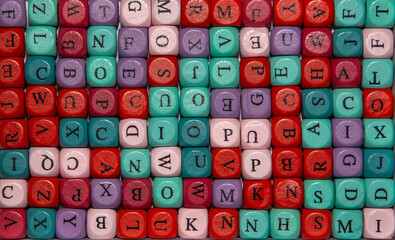 Close-up with cubes with letters in various colors. Background image with colorful blocks with various alphabet letters