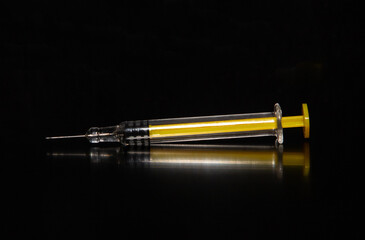 Close-up with a syringe on a black background