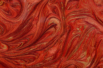 Closeup of red fluid metallic paint textured background
