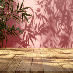 wooden table with bamboo leaves casting shadows on a pink wall.