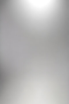 An abstract, silver gradient background with high resolution. It’s plain, smooth, and soft lighting, suitable for portrait studio photography.