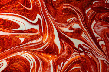 Closeup of red fluid metallic paint textured background