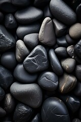 b'Close-up of a pile of smooth, round, black stones'