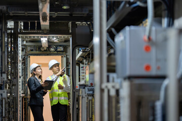 The power plant embodies the energy industry's commitment to excellence and sustainability, with male and female engineers working in tandem to optimize energy production.