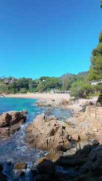 Vertical video of a beach in the Mediterranean blue sea, turquoise, sky, copy space