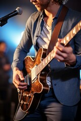 b'Close-up of a musician playing the guitar on stage'