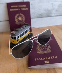 European Union passports with sunglasses and souvenirs of yellow tram typical of Lisbon.  Remember...