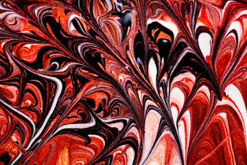 Closeup of red fluid metallic paint textured background