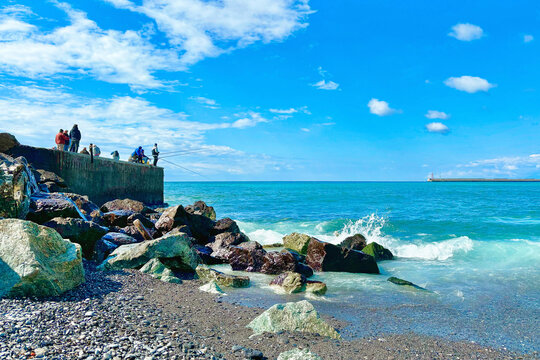 pescatori sul mare mediterraneo a genova in italia,  fishermen  on the mediterranean sea in genoa in italy 