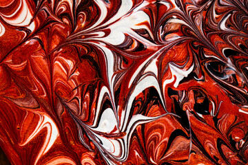 Closeup of red fluid metallic paint textured background