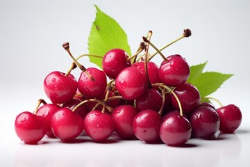 b'A pile of red cherries with green leaves'