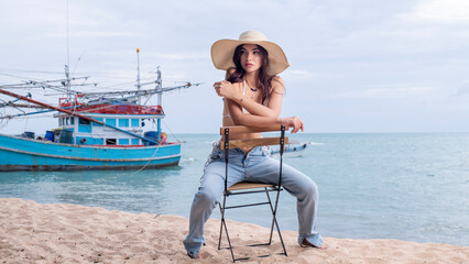 Woman Caucasian stay on beach wearing bikini and jeans with hat and sunglass on the sea beach is summer holidays concept. - 796759038