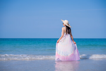 Happy sexy Asian traveller woman wear colorful beach dress and hat show enjoys on tropical beach vacation in summer holidays	 - 796759296
