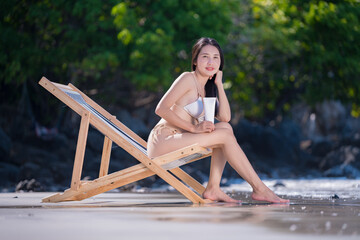 Sexy woman with bikini used applying sun cream on body is sun block skin protection and body care cream on beach summer holiday vacation .	 - 796759435