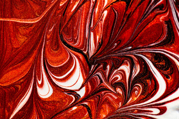 Closeup of red fluid metallic paint textured background
