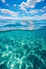 Fototapeta na wymiar b'Half and half photo of a calm ocean'