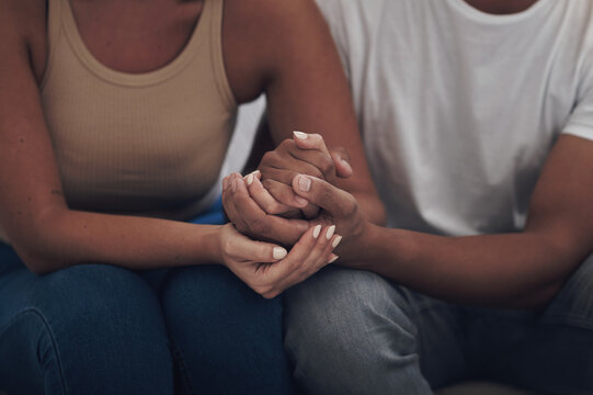 Couple, love and holding hands for trust, care and solidarity or romance with respect. Compassion, partnership and support for bad news in relationship, grief and marriage therapy for hope and unity