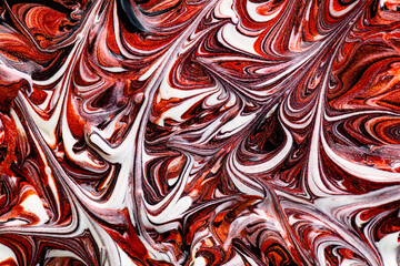 Closeup of red fluid metallic paint textured background