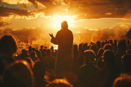 Rear shot of Jesus at The Sermon on the Mount, the setting sun creating a silhouette as He speaks to an absorbed crowd,