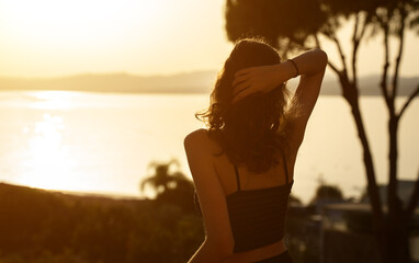 Girl at sunset on the balcony.