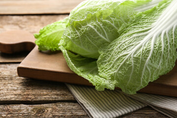 Fresh ripe Chinese cabbage on wooden table, closeup
