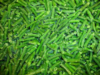 Сlose-up green beans in market frozen fresh vegetables food background. Healthy vegetarian beans concepts, text space. Frozen beans green vegetable background. Green frozen cut french bean texture