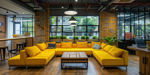 Modern office interior with stylish yellow couches and a coffee table in the center of the room