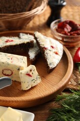 Tasty butter with dill, chili pepper and rye bread on table