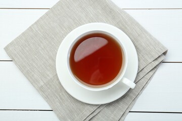 Fototapeta premium Aromatic tea in cup on white wooden table, top view