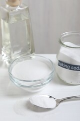 Baking soda and vinegar on white wooden table