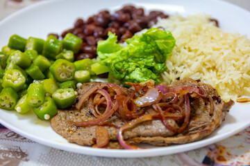 Traditional rustic Brazilian lunch, beans, rice, steak, okra and lettuce. Executive made dish