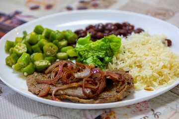 Traditional rustic Brazilian lunch, beans, rice, steak, okra and lettuce. Executive made dish