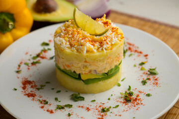 Causa Peruana. Causa Lima is a traditional starter of Peruvian cuisine made with potato, avocado, chicken or tuna.