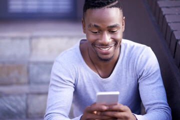 Phone, typing and happy black man online, reading email or notification for social media blog at...