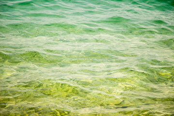 Clean, clear sea water surface in bright sunlight, water texture