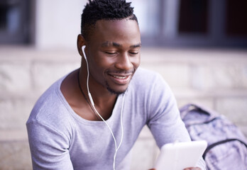 Student, black man and online in city with tablet for information on university schedule or classes. Male pupil, digital tech and internet with music on college steps, happy and reading ebook on app.