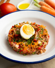 Summer salad with lentils, vegetables and boiled egg.