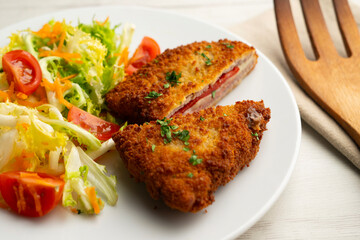 Cachopo is a Spanish dish that consists of two breaded beef fillets stuffed with cheese and serrano...