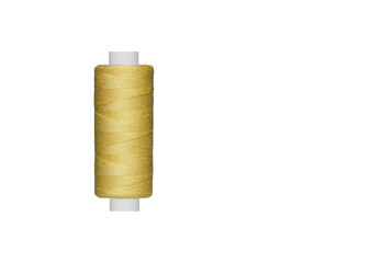 yellow spool of sewing thread isolated on white background close up