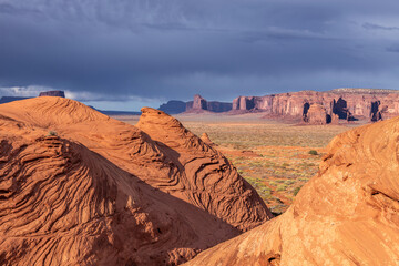 Monument Valley panorama shown during an eerie sunset as a storm passes through