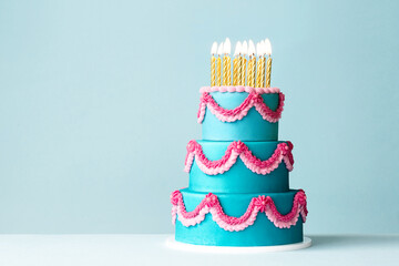 Tiered celebration birthday cake with ornate piped buttercream frills