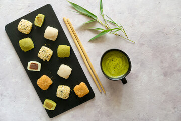 Mochi Collection with Matcha Tea on Textured Background