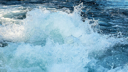 Sea water with foamy surface close-up. Boat trip on Lake Garda. Top view of turquoise rushing water. Foamy trail from a boat. Selective focus.Mobilofoto - obrazy, fototapety, plakaty
