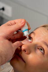 close-up in an ophthalmology clinic Freezing drops are put into a girl's eye