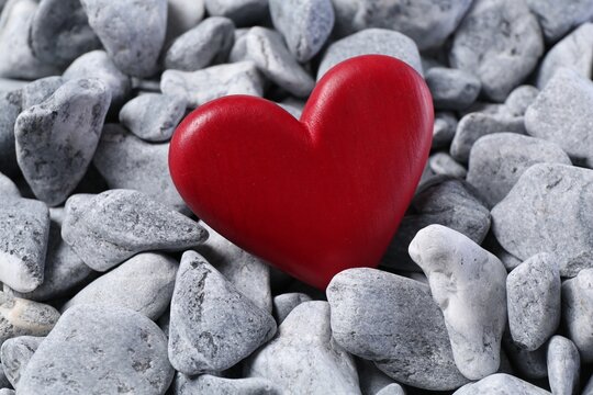 Red decorative heart on grey stones, closeup