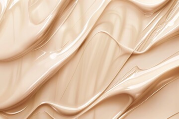Obraz premium cosmetic tonal foundation cream or serum glowing texture on beige background in wavy lines